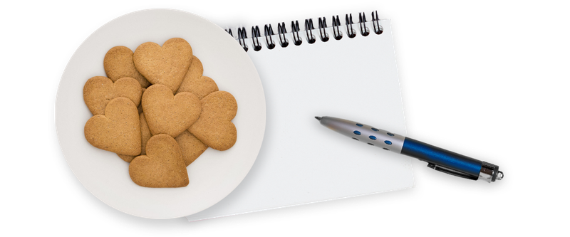 Heart-shaped cookies and notepad with pen