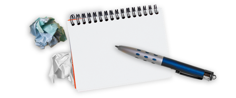 Crunched up papers and notebook with pen